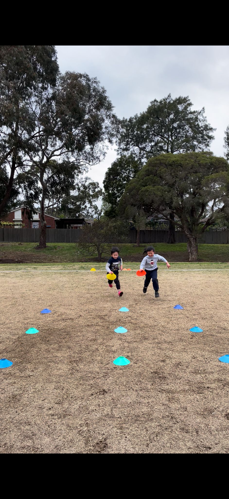 Elevate Football Academy kids running through agility disc cones